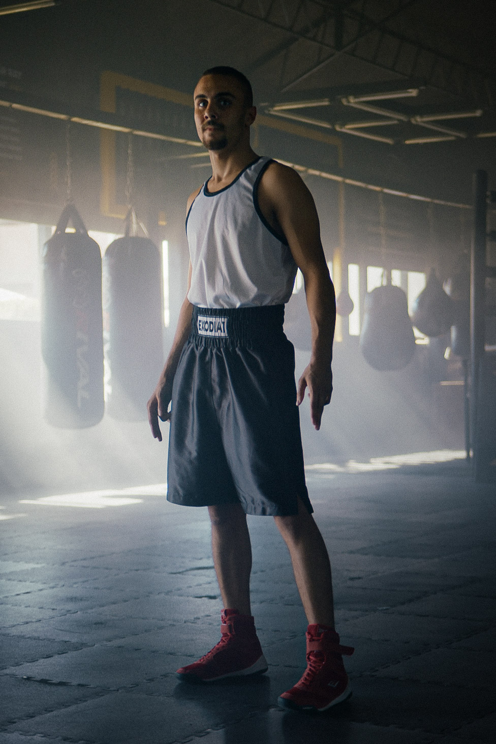 Boxer training in Exodia 1 Black Satin Boxing Shorts, made in Egypt for optimal comfort, durability, and flexibility. Perfect for boxing, Muay Thai, and fitness training.